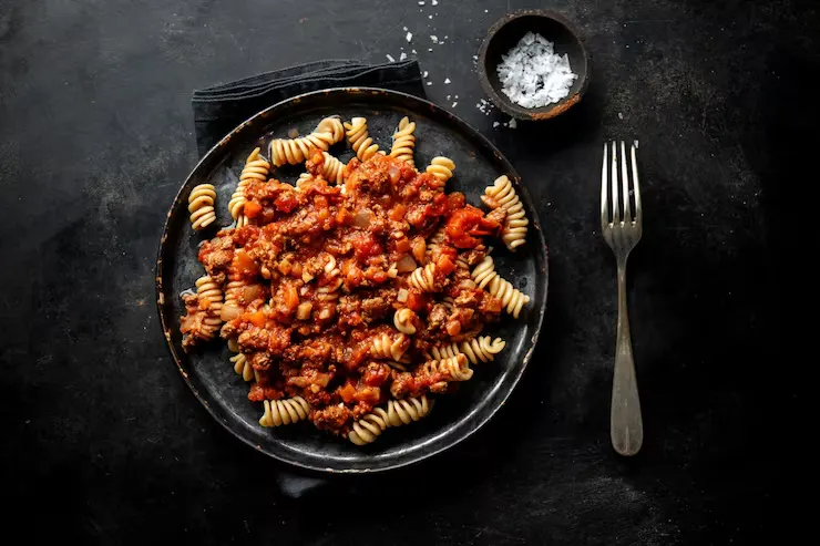 pasta-with-sauce-bolognese-served-plate-dark-background