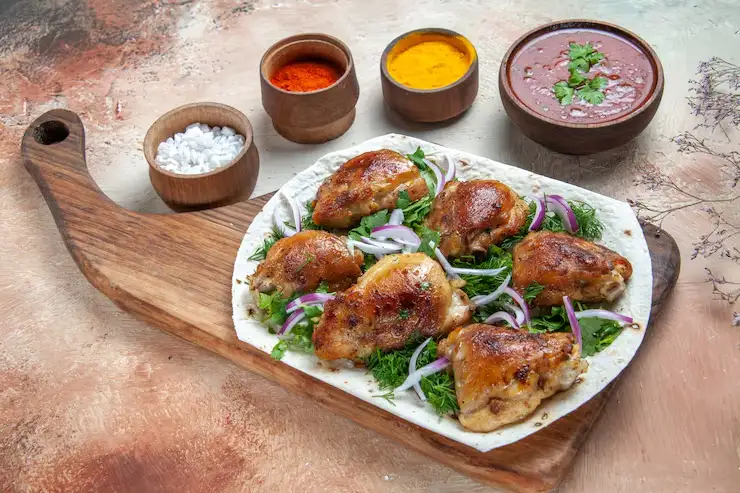 side-close-up-view-chicken-chicken-with-herbs-lavash-bowls-sauce-colorful-spices