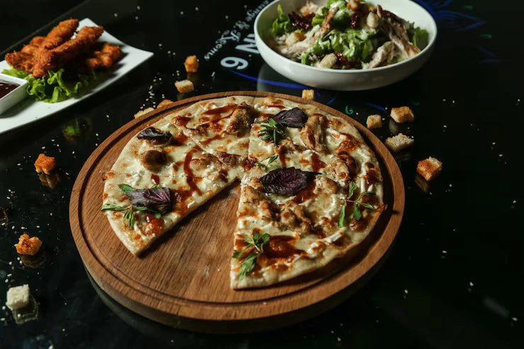 side-view-chicken-pizza-tray-with-salad-table